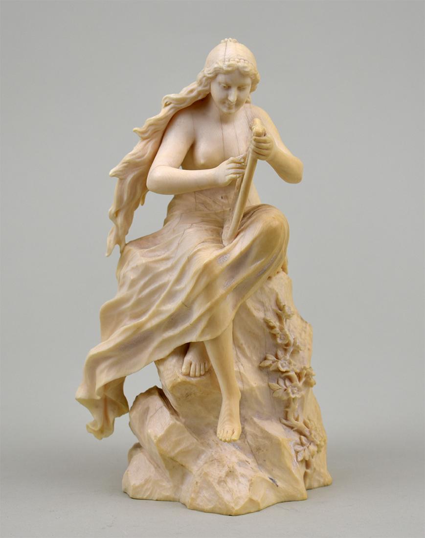 CONT FIGURE OF A CLASSICAL MAIDEN PLAYING A HARP: 19th Century. Probably German. The long-haired maiden seated upon a rock. Height 7 in. Width 3 in. (Cond: good)