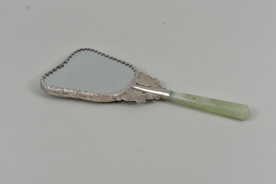 CHINESE HARDSTONE AND SILVERED METAL HAND MIRROR: 20th Century. Decorated with a bird amidst foliage. Width 9 in. (Cond: good)