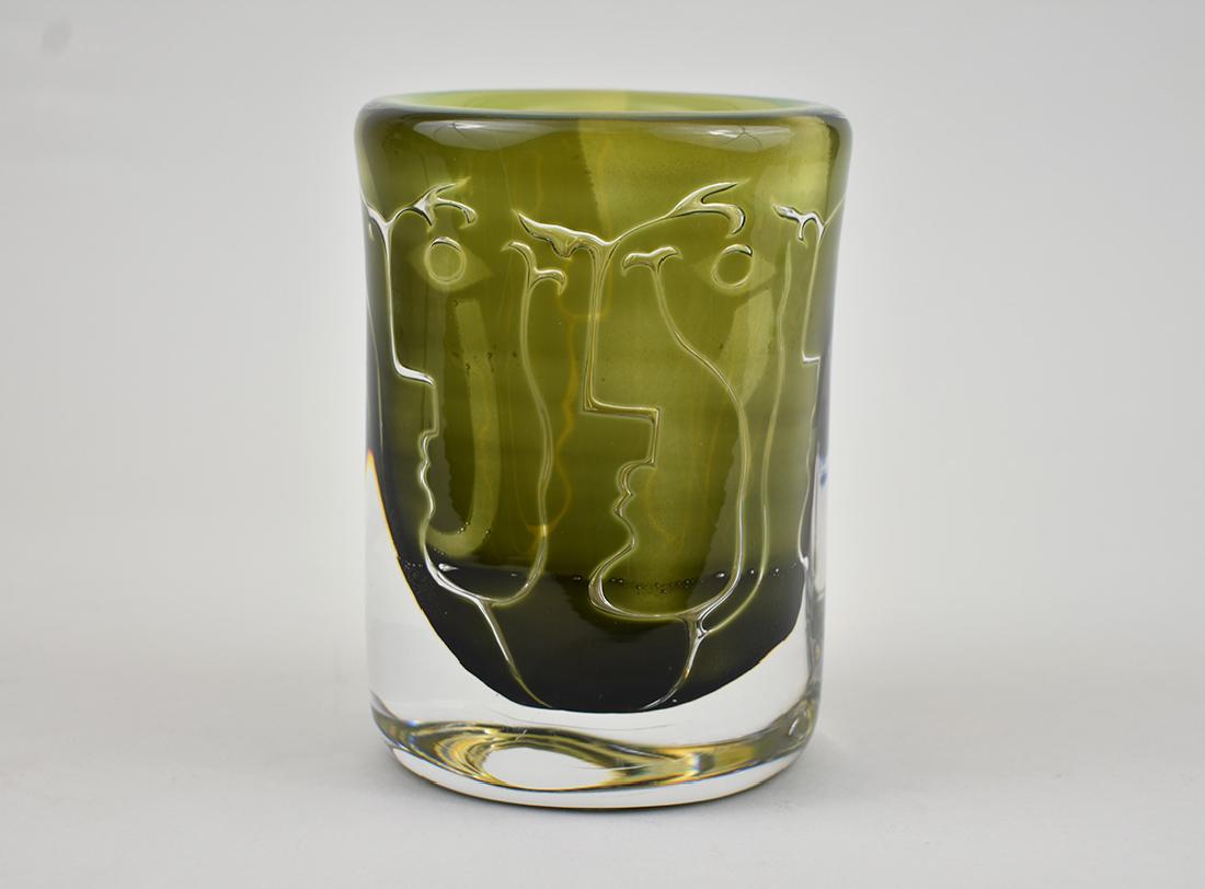 ORREFORS COLORLESS & FOREST GREEN GLASS VASE: Modern. Signed Orrefors, Jugeberg (?), numbered 957715. Internally decorated with linear faces. Height 7 in. Diameter 5 in. (Cond good)