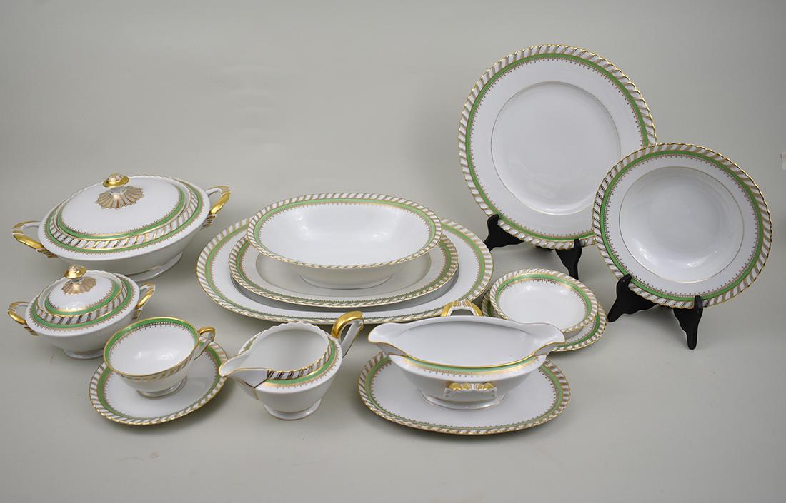 GERMAN APPLE GREEN & GILT 91 PC PORCELAIN SERVICE: Early 20th Century. The underside with various marks. With wave borders and an apple green band and with gilt highlights. Comprising: 2 oval platters, a large covered circular stew bowl, a sauceboat w