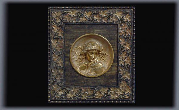 Antique Bas-Relief Plaque Mounted in a Victorian Fr: Antique Bas-Relief Plaque Mounted in a Victorian Frame. The deeply cast center disk depicting a maiden in a cloak measuring 9 inches across. Mounted in a 3 inch wide ornate grapevine motif beaded bord