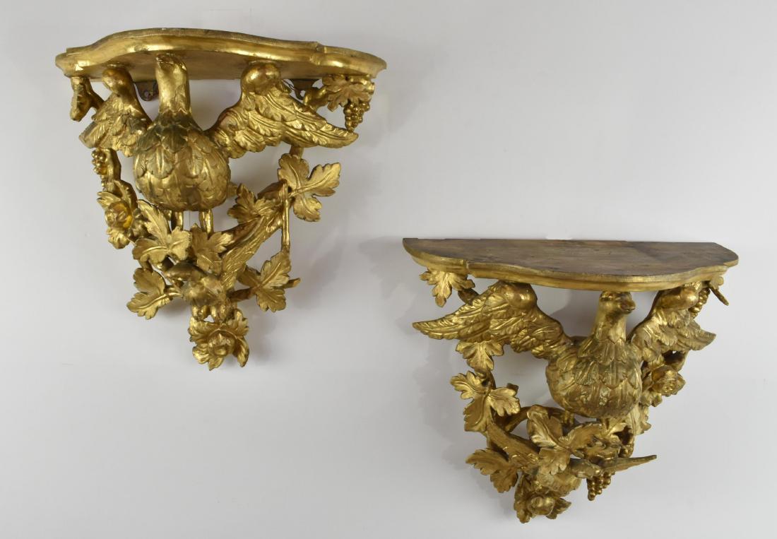PR. OF CONTINENTAL DOUBLE EAGLE GILTWOOD BRACKETS: Possibly Austrian. Circa 1860. Each shaped shelf above a large displayed winged eagle above a smaller eagle, both perched on fruiting branches. Height 16.5 in. Width 17.5 in. Depth 10 in. (Cond: good,