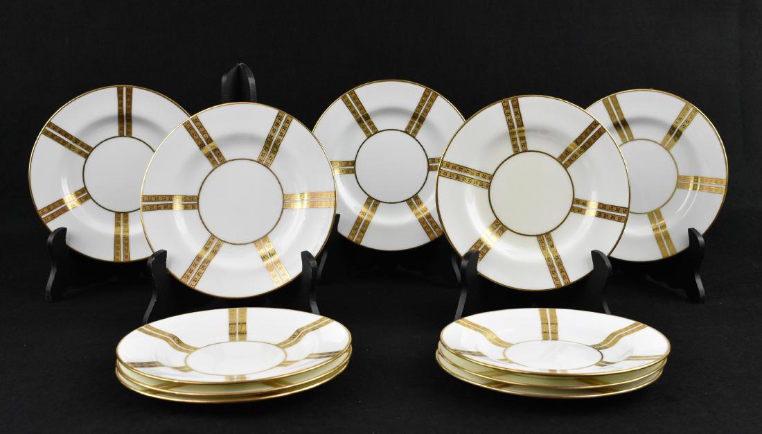 ELEVEN MINTON PARCEL GILT PORCELAIN DESSERT PLATES: Mid 20th Century. The underside with Minton logo and various factory marks. Circular with a sloping shallow center recess decorated with multiple double gilt bands. Diameter 6 in. (Cond: good)