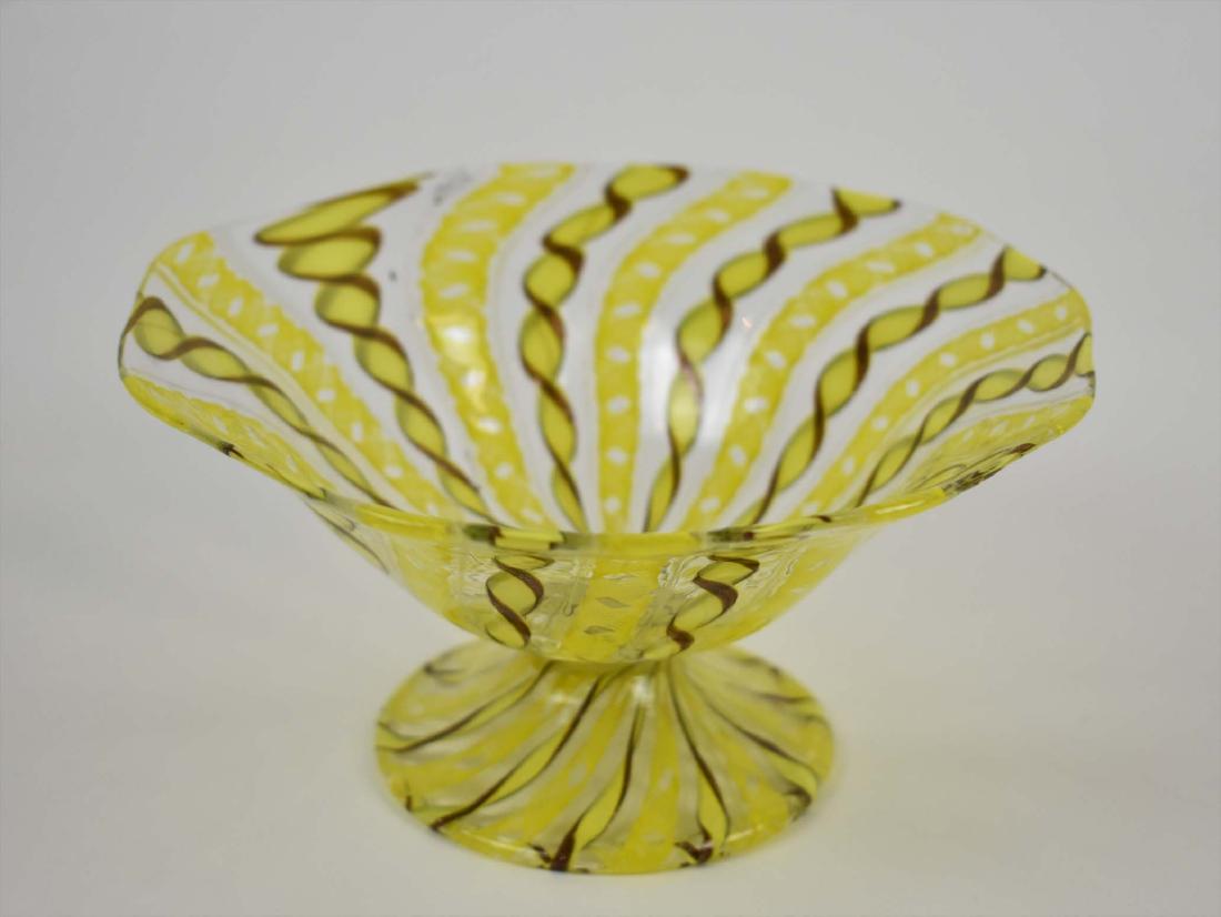 VENETIAN LATTICINO COUPE: Modern. The colorless glass with a flared bowl on a circular foot, with yellow and gold fleck spiral bands. Height 3.75 in. Diameter 7 in. (Cond: good)
