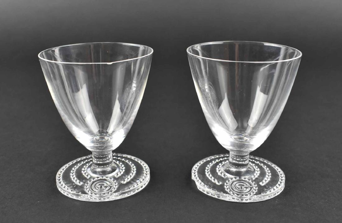 RARE PR. LALIQUE WINE GLASSES FROM S.S. NORMANDIE: Circa 1934. Inscribed signature R Lalique France. The tapered bell shaped bowls on a short stem above a circular foot with a beaded border centering the initials CTG, for the ships owner, the Compagni