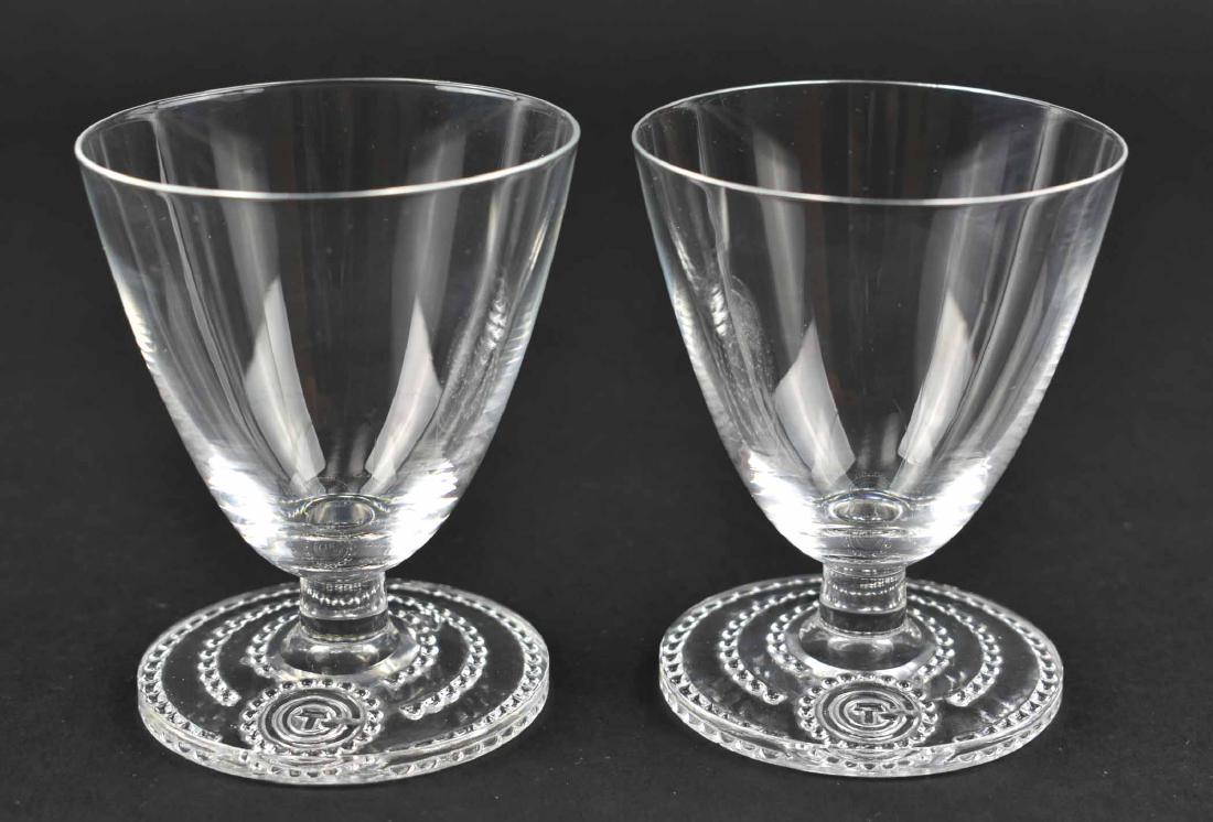 RARE PR. LALIQUE WINE GLASSES FROM S.S. NORMANDIE: Circa 1934. Inscribed signature R Lalique France. The tapered bell shaped bowls on a short stem above a circular foot with a beaded border centering the initials CTG, for the ship’s owner, the Compa