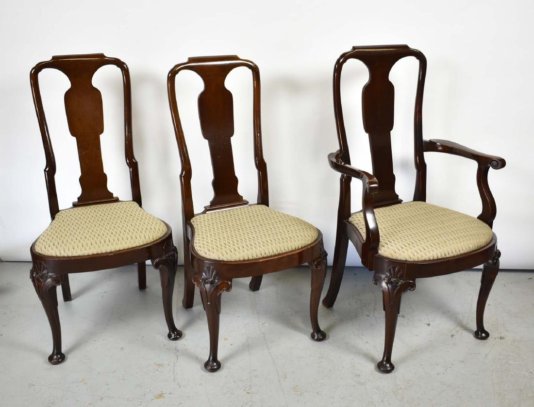 SET OF 8 QUEEN ANN STYLE MAHOGANY DINING CHAIRS: Comprising two arm and eight side chairs. The curved crests over a solid vase form splat, the compass shaped drop-in seats on shell and scroll carved cabriole legs ending in pad feet. (Cond: good)