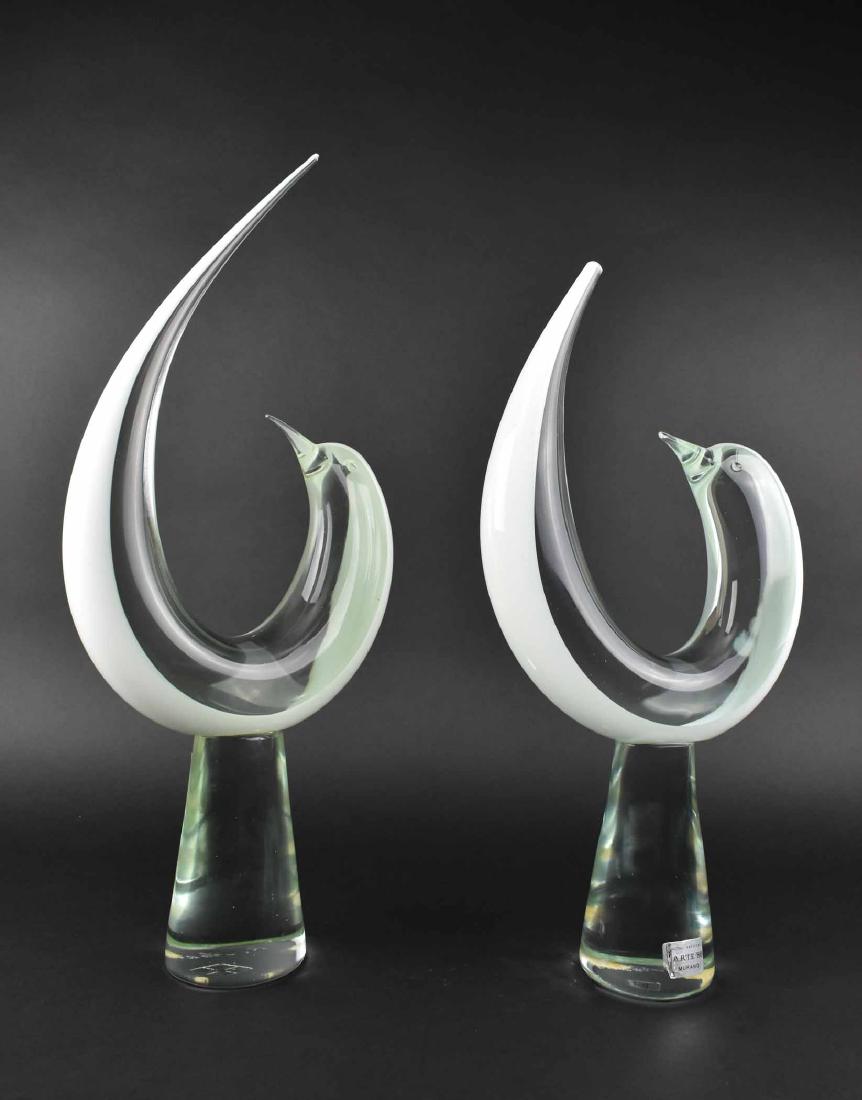 PAIR OF VETRI MURANO ART GLASS DOLPHINS: Italian. Engraved signature. Each stylized dolphin poised in an upward curve atop a pedestal. Height overall 23 in. Width 10 in. (Cond: one tail lacking half inch from tail tip, re-polished)