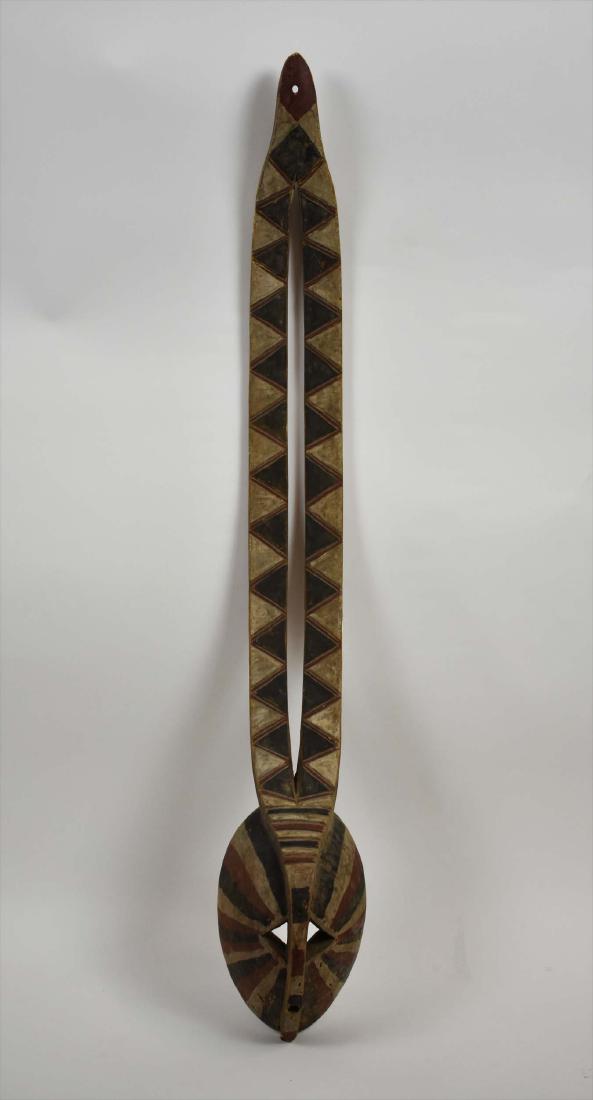 AFRICAN BOBO PAINTED AND CARVED ANTELOPE FACE MASK: Painted in black, white and brown, the face with slits for the eyes and nose, with two long antlers. Height 46 in. Width at face 6.5 in. (Cond: good)