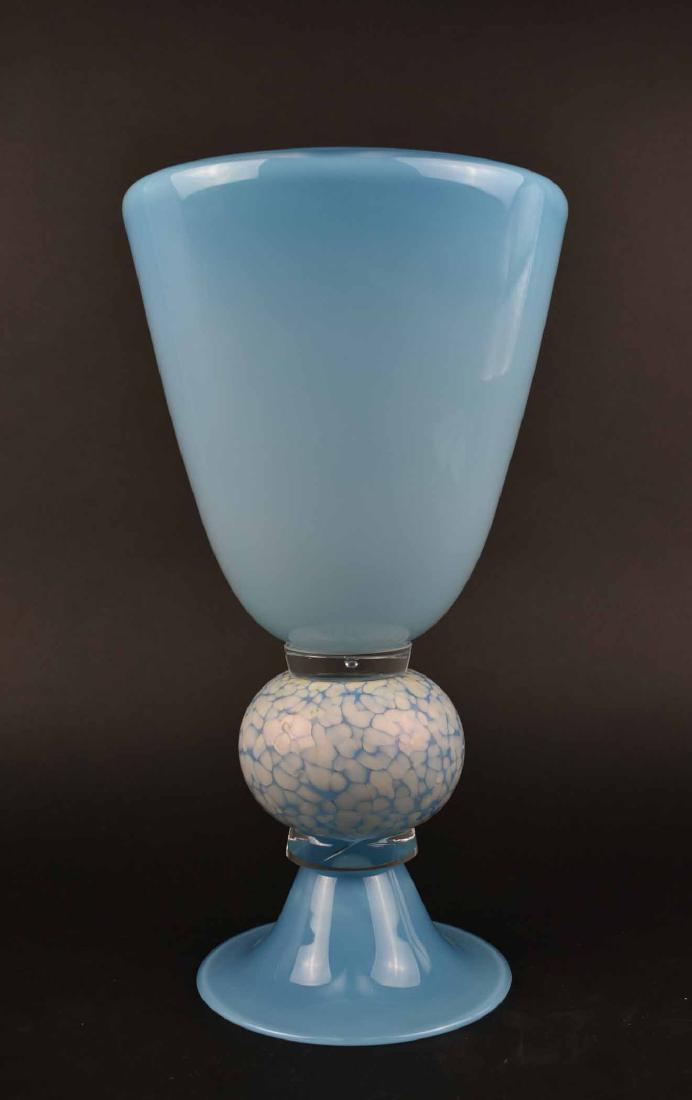 LARGE STUDIO GLASS VASE: Modern. Unsigned. The chalice shaped blue vessel transitioning from dark to light blue, with a white mottled spherical center element, on a circular foot. Height 15 in. Diameter at rim 8 in. (Cond: go