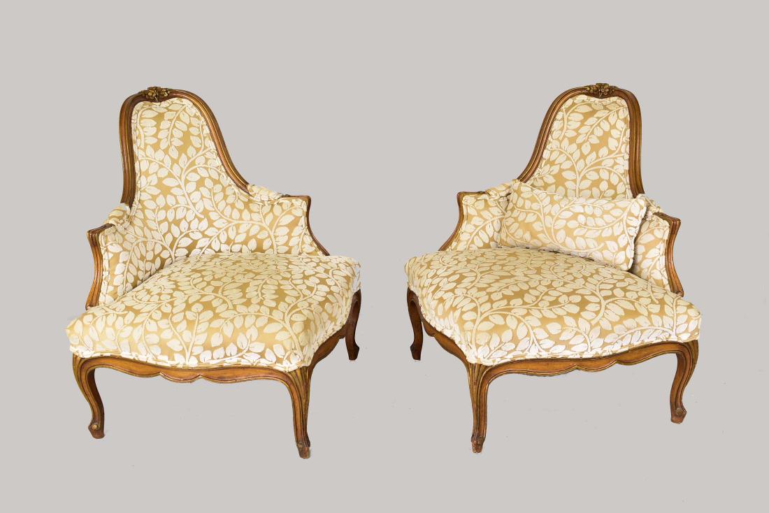 PAIR LOUIS XV STYLE PARCEL GILT CORNER CHAIRS: 20th Century. Each with a high arched back and wide seat on cabriole legs; the arms and legs with parcel gilt scrolls and foliage. Height of back 34 in. Height seat to floor 13 in. Width of seat 35 in