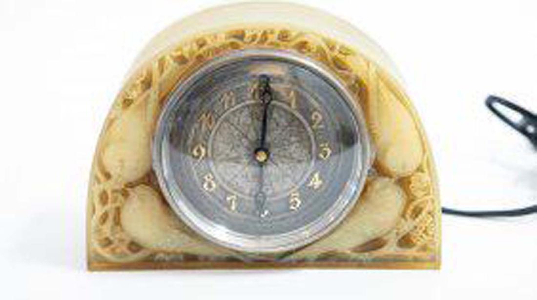 LALIQUE MOINEAUX ATO COLORED GLASS CLOCK: Molded R. Lalique signature, lower right front. Circa 1925. The textured metal dial with Arabic numerals, marked AU LINGOT D'OR, the brass movement marked Leon Hata. Height 6.25 in. Width 8 .5 in. (Co