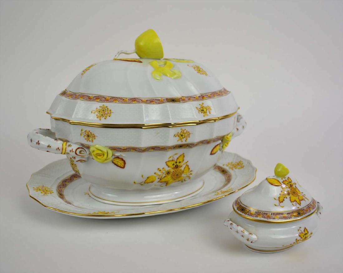 HEREND PORCELAIN SAUCE AND A SOUP TUREEN: Modern, both marked on the underside. Covered, the soup tureen with an under plate, decorated with yellow foliage highlighted in gilt, with molded bodies, lids and plates, and a lemon finial. Height 8
