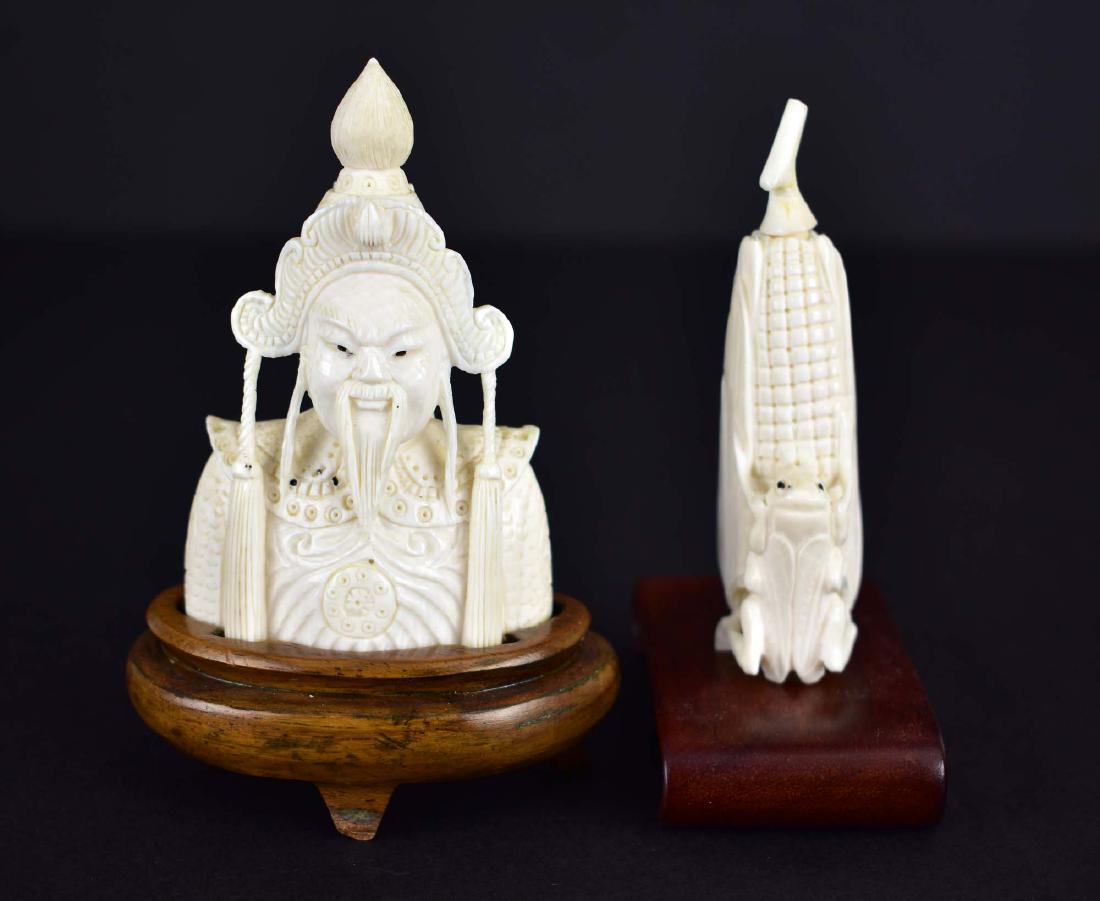 TWO CHINESE CARVED SNUFF BOTTLES: The first an ear of corn with a locust, the second, a torso of a general, both with stoppers and spoons. Heights 2 in., 2.5 in. (Cond: good)