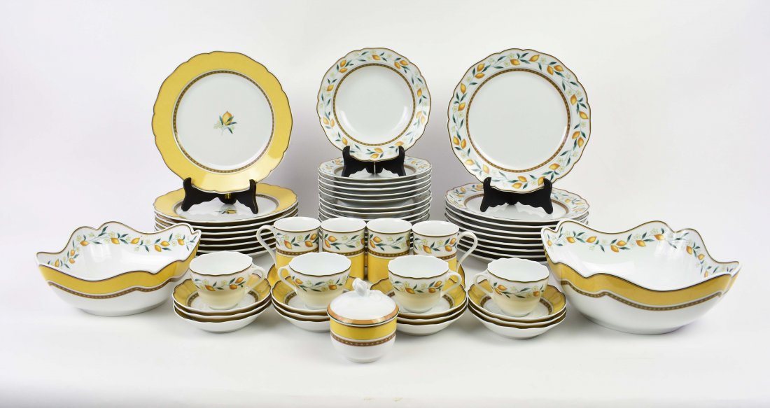 LARGE HUTSCHENREUTHEN PORCELAIN DINNER SERVICE: German, 20th Century. In a Medley Pattern. Each piece decorated with either a lemon blossom or a lemon blossom vine, with a yellow border. Comprising: dinner plates, luncheon plates, bowls, numerous s