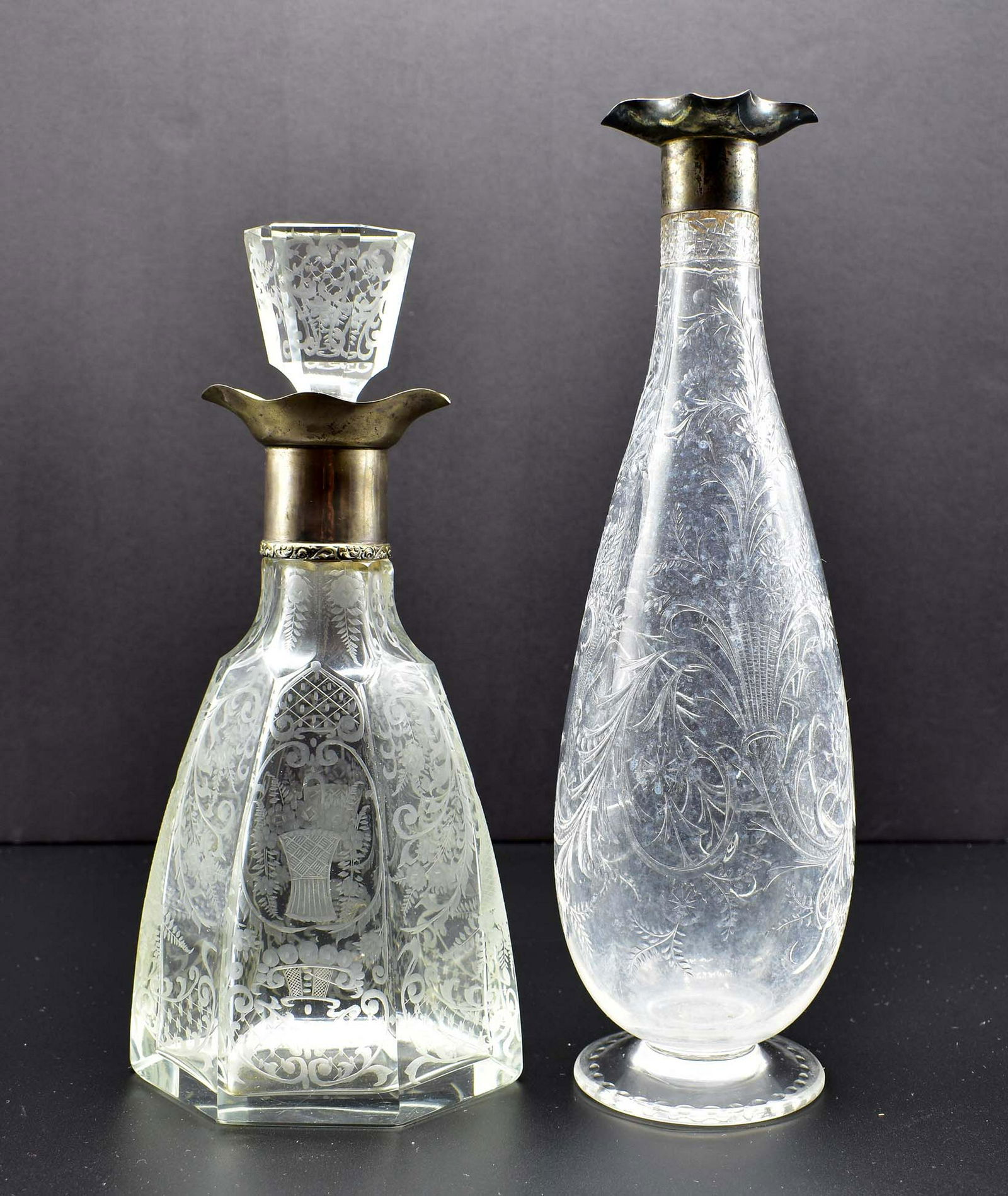 ENGLISH ROCK CRYSTAL EWER & LOBMEYR GLASS EWER: The first, a Thomas Webb silver-mounted engraved example. The second also silver-mounted, with a glass stopper, of hexagonal shape and engraved with foliage and scrolls. Heights 13 in., 11.25 in., res