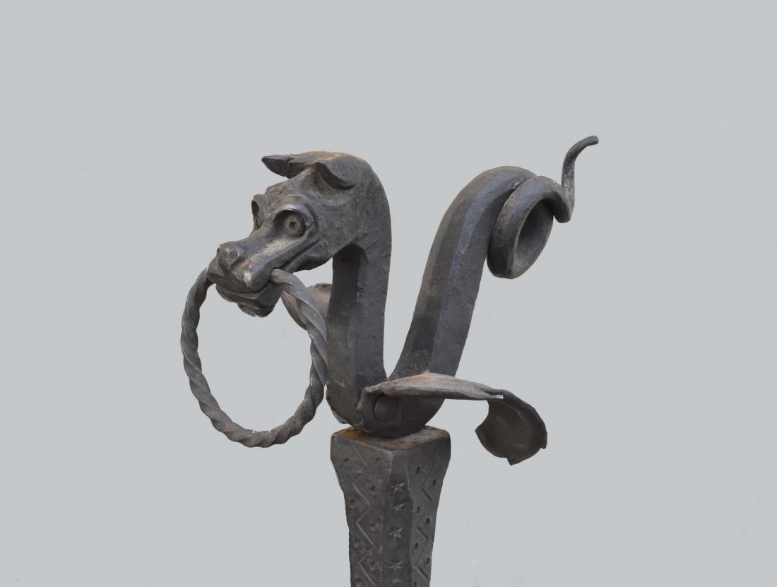 PAIR OF BARQUE STYLE IRON FIREPLACE ANDIRONS: Late 19th/Early 20th Century. The posts surmounted by dragonheads, on strap-work arched supports. Height 42 in. Depth 41 in. Width 17 in. (Cond: oxidized surface, but good condition)