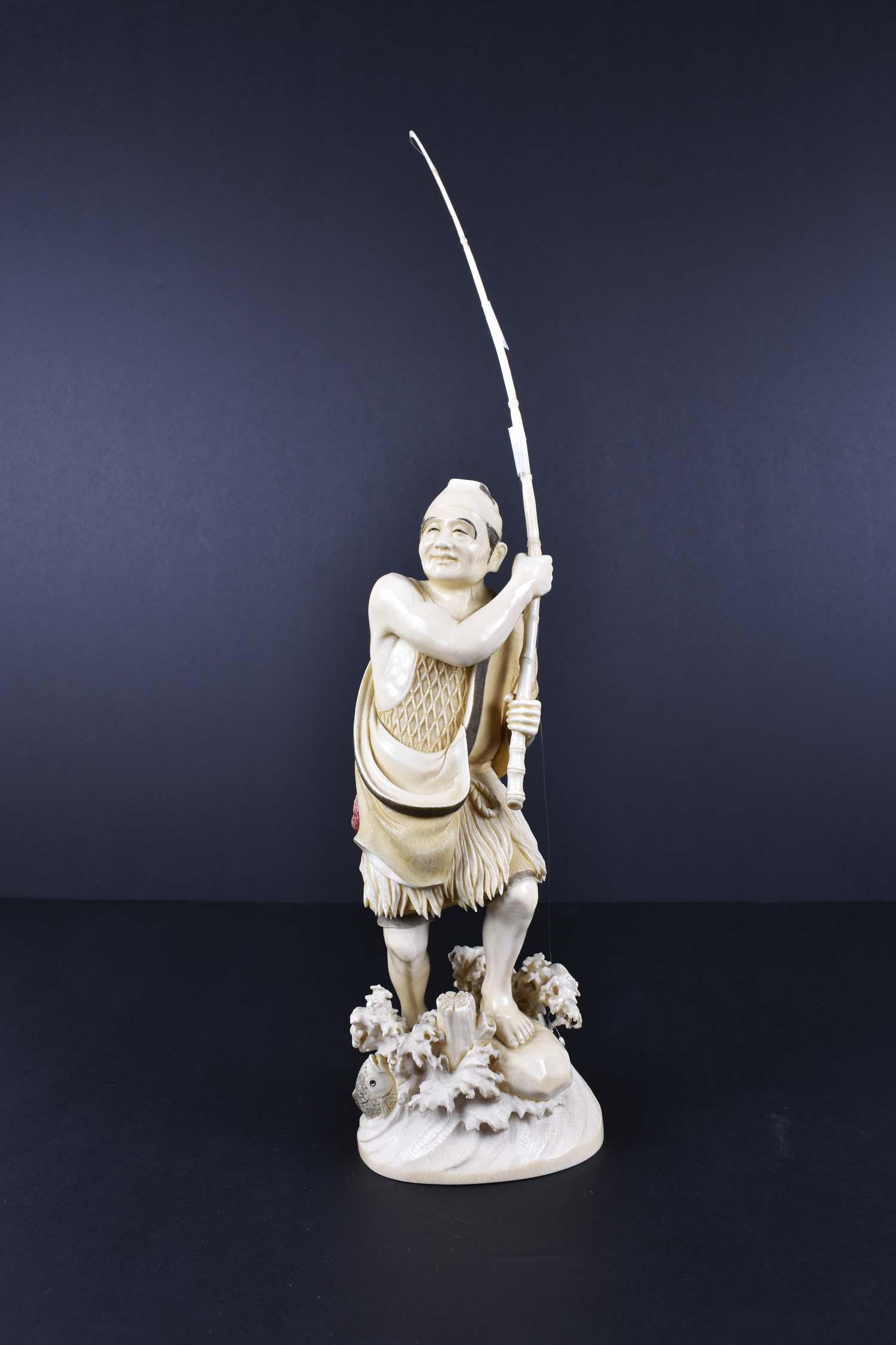 LARGE IMPRESSIVE JAPANESE OKIMONO OF A FISHERMAN: Meiji Period. Signed. Standing atop waves with leaping fish, dressed in his fishing attire, holding a long rod. Height to tip of pole 18 in. (Cond: good)
