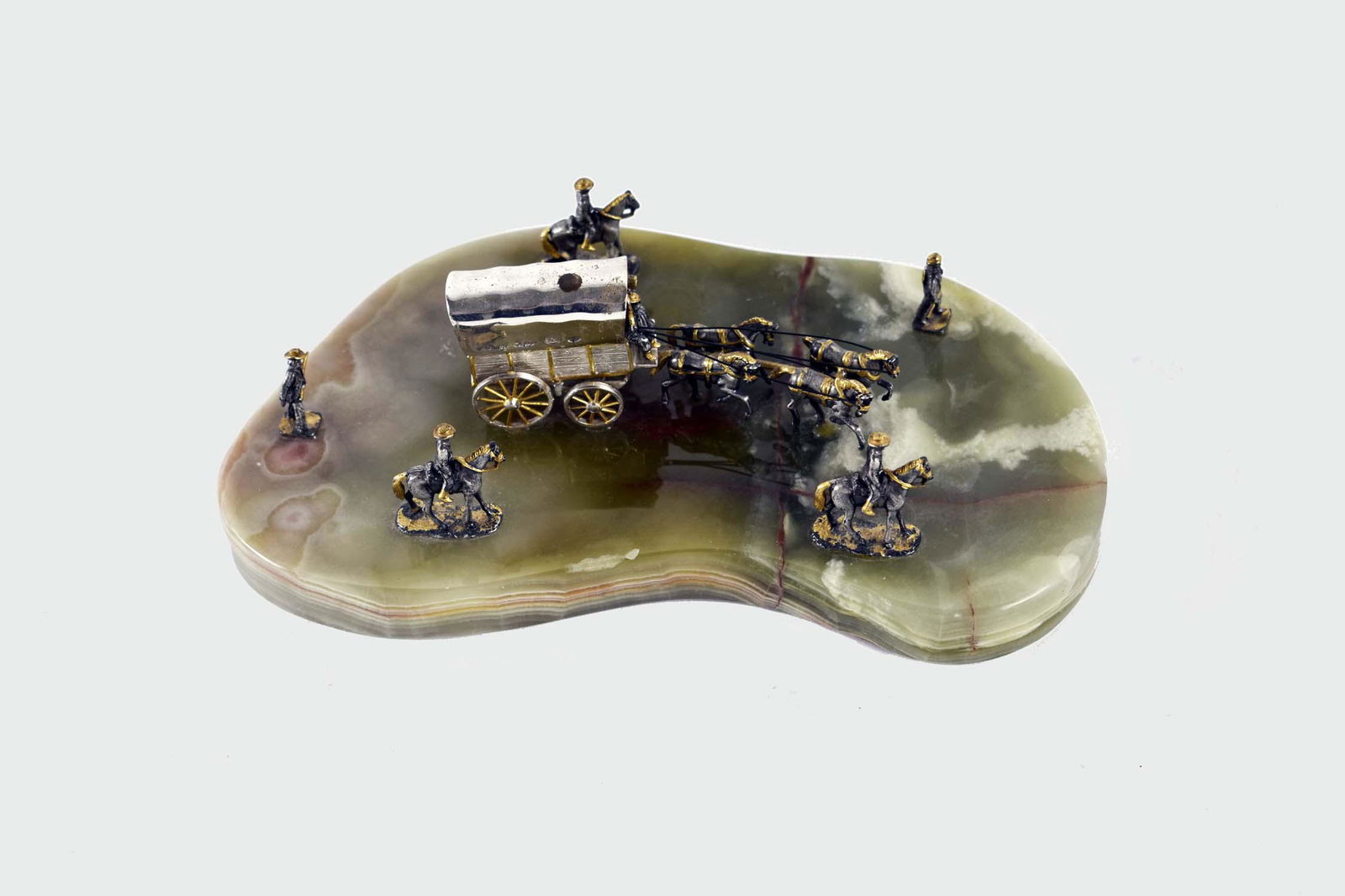 VASARI SILVER & GILT ON ONYX STAGECOACH SCENE: The stagecoach signed. The horse drawn coach with cowboys on horseback and infantry, set on an onyx base. Height of coach 1.75 in. Width 8.75 in. (Cond: one fig. man horse dislodged, repaired leg)