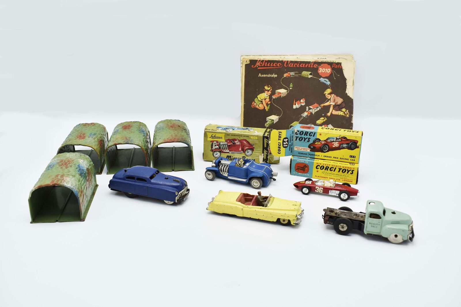 SIX VARIOUS VINTAGE TOY CARS: 1940â€™s through 1950â€™s. Comprising: a Schuco Varianto-Limo, 3041, painted; a Schuco truck, 3042, painted pale green, US Zone West Germany; a Schuco Micro racer, 1036, painted blue, w/orig