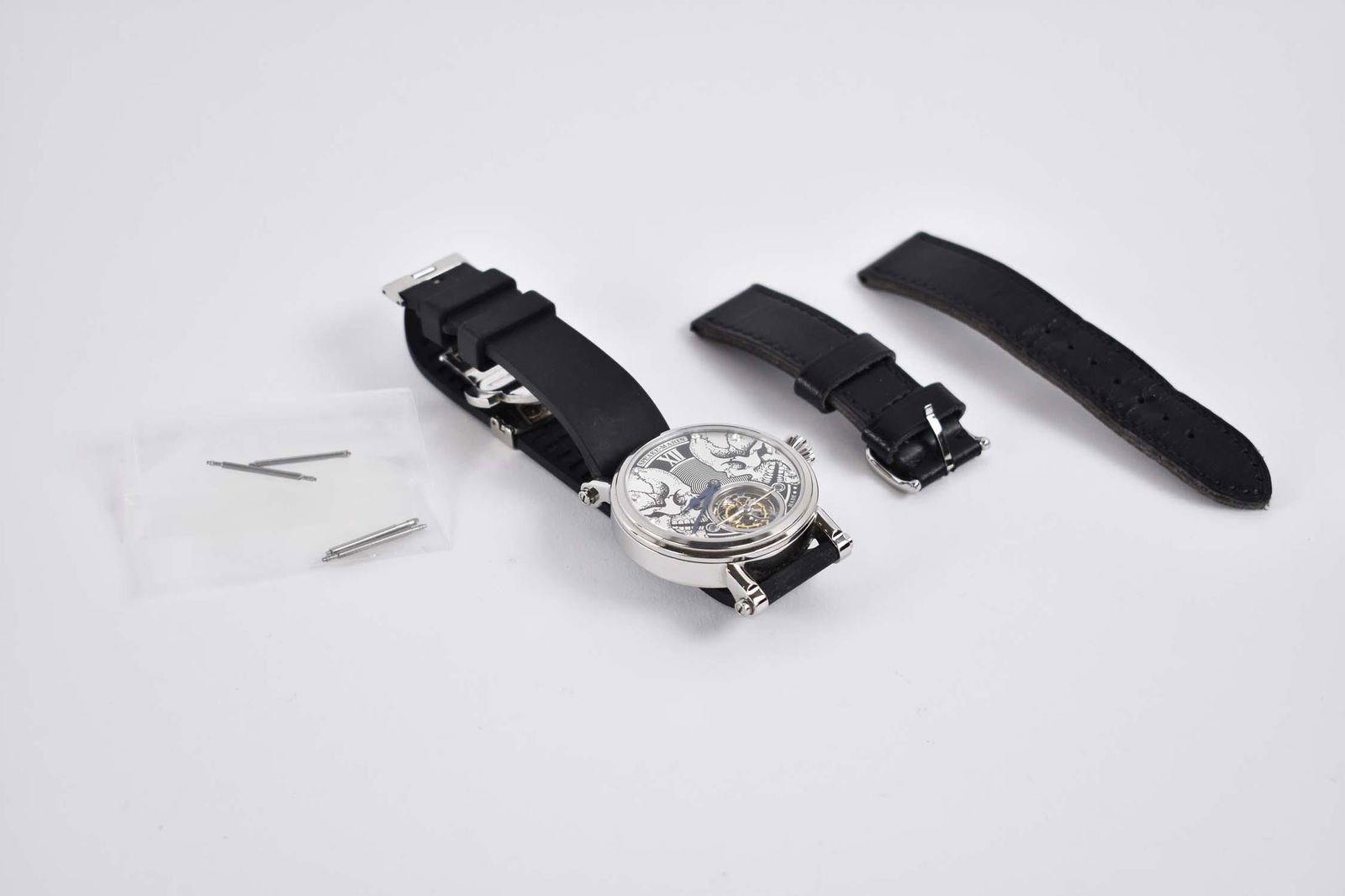 SPEAKE-MARIN SKULL FACE TOURBILLION REPLICA WATCH: 2002 EQ Stainless Steel White Skull Dial Swiss Watch. Automatic movement. Diamond Hour Markers. Black Rubber Band with deployment clasp. Accompanied with the black leather strap.Good Condition. In wor