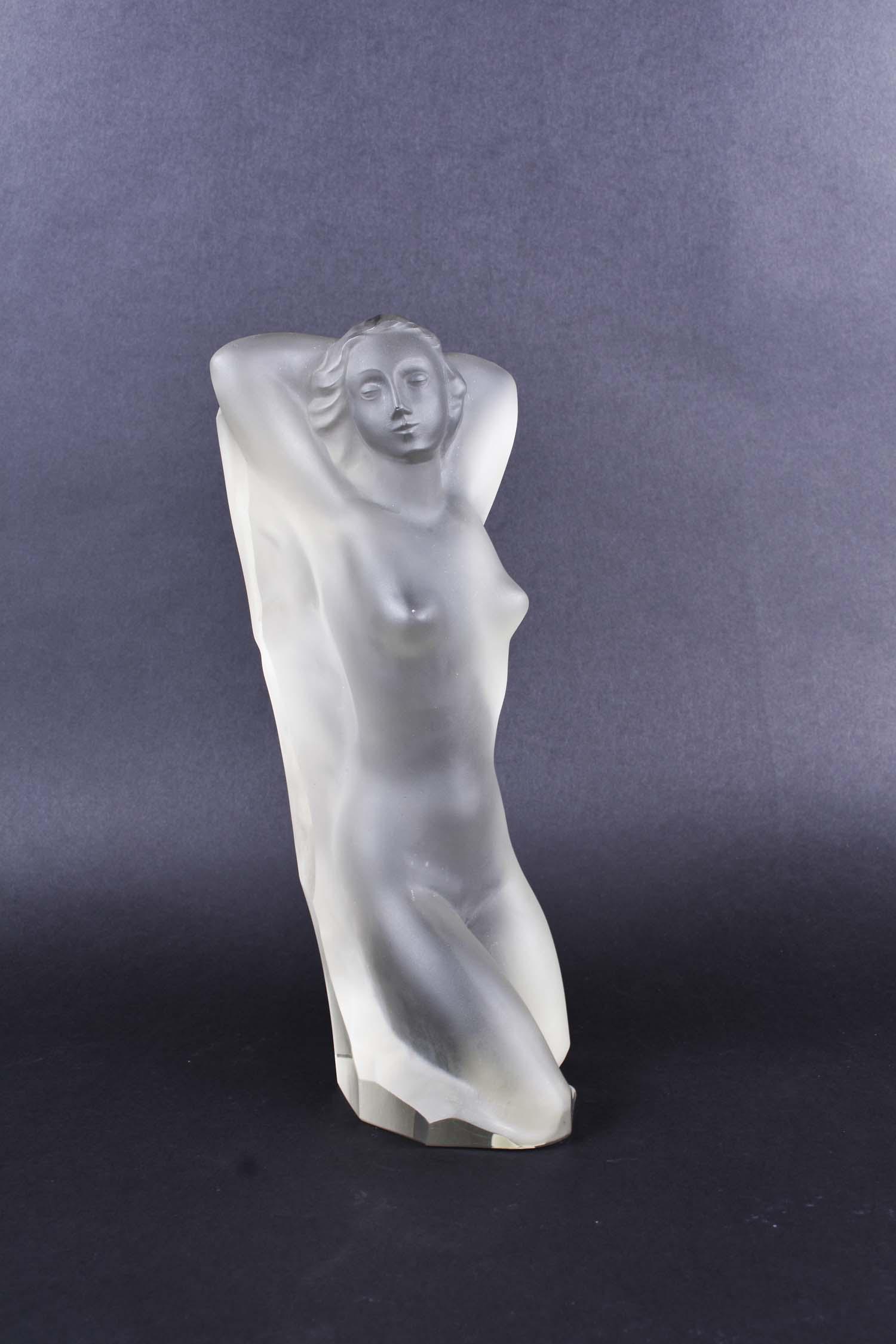 ENA ROTTENBERG (CZECH. 1893-1952) GLASS NUDE SCULPTURE: Cast Glass. First half 20th Cent. Molded to depict the woman as if she is emerging from a block of stone. Height 12 in. Width 5.75 in. Depth 5 in. (Cond: good, but for a micro chip to the tip of nose.