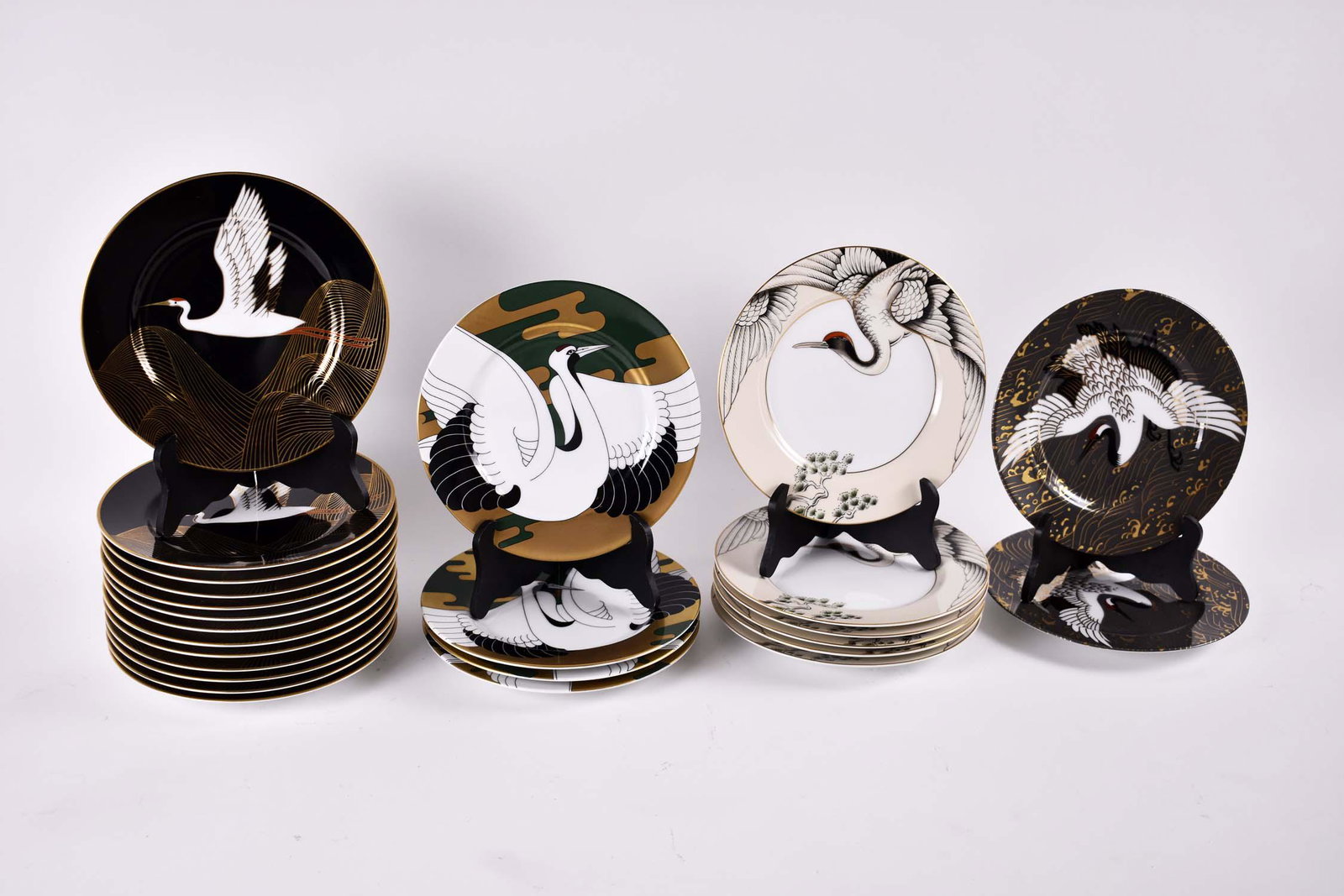 TWENTY-FIVE VARIOUS FITZ & FLOYD PORCELAIN DESSERT: Marked on the undersides. Some in pairs, others in small sets, all with a crane in flight. Diameter 7.5in. (Cond: good)