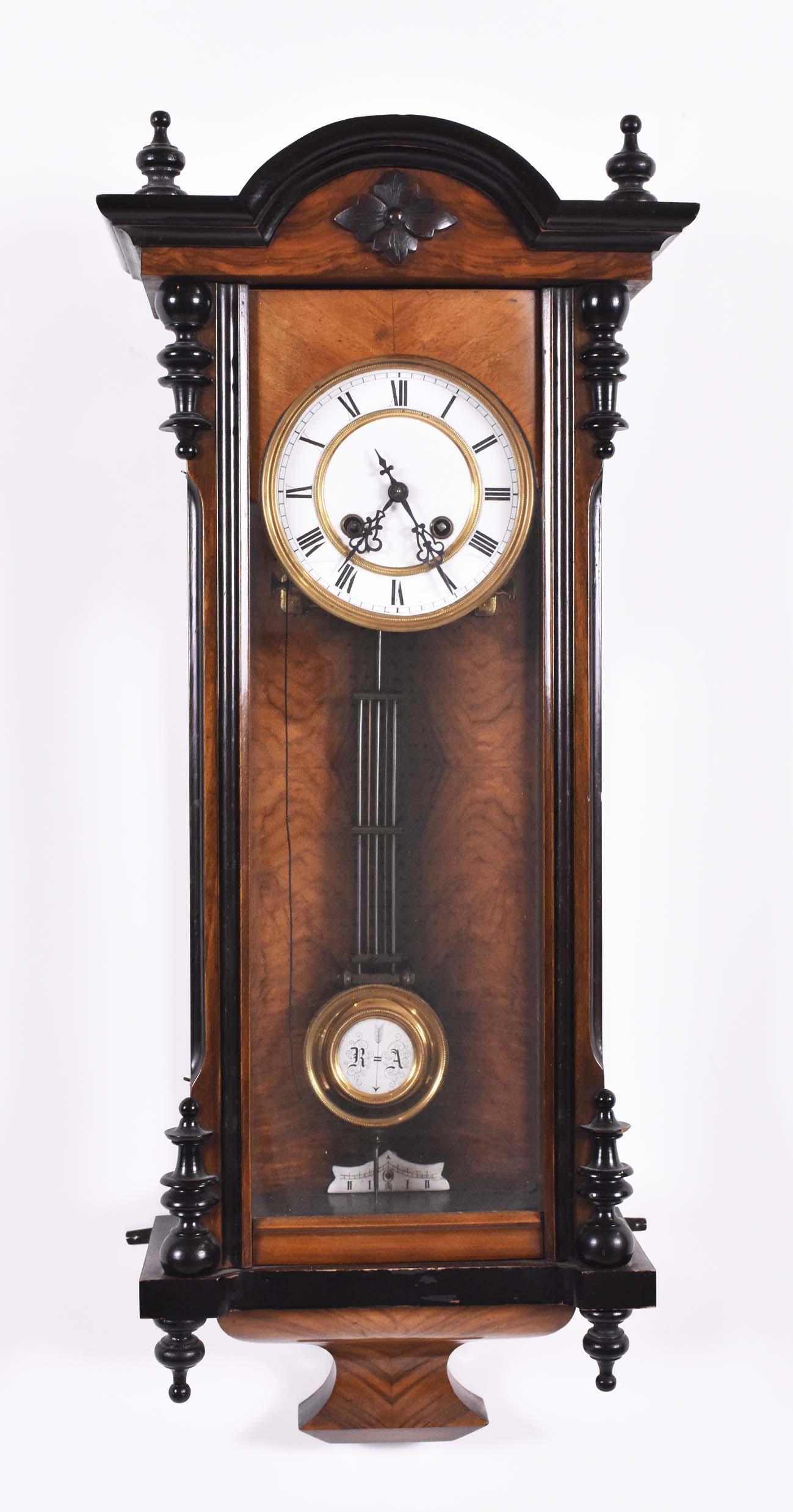 ENGLISH VARIOUS WOOD INLAID WALL CLOCK: 19th Century. In a combination Neoclassical and Gothic style, with fret carved pendants at the side and a scroll at the base. Height 31 in. Width 17 in. (Cond: restored)