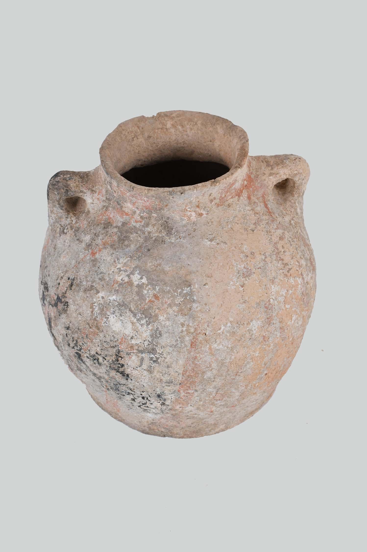 LATE BRONZE AGE TERRA COTTA TWO-HANDLED WATER JAR: Judea, 3000 B.C.E. Inscribed B.C. 3000 Judea M. Dayan. The spherical shaped jar, with a circular foot, and two angled handles placed at the shoulder. Height 8 in. (Cond: chips to rim, heavy earth depo