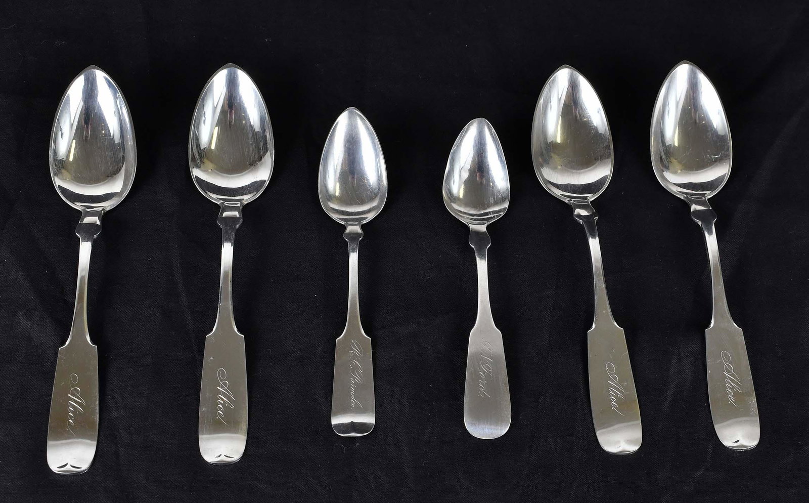 SIX AMERICAN STERLING SILVER SPOONS: Third Quarter 19th Century. Marked D.H. Buell. Comprising a pair of fiddleback grapefruit spoons, incised in script F.N. Ford or R.C. Parmelee and a set of four similar, each incised Alice. Troy oz. 6