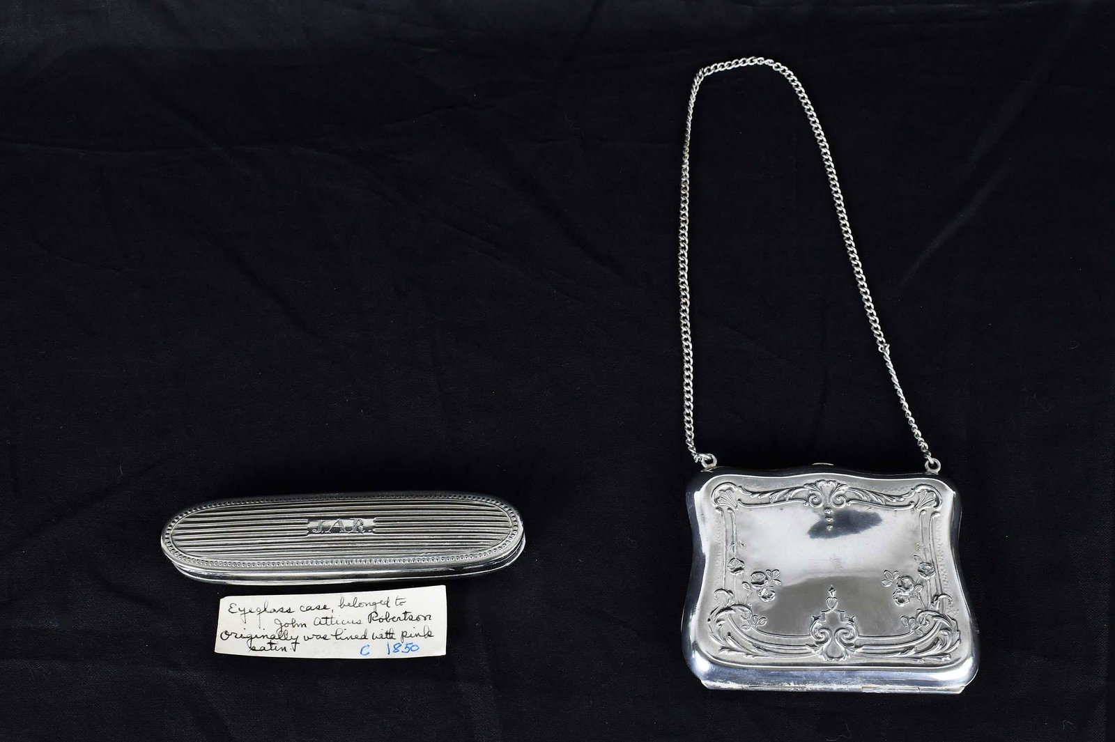 GERMAN ROCOCO STYLE SILVER LADIES CARD CASE: Late 19th Century. Marked Ger. Silver. Chased with foliage and scrolls, together with a silver plate eyeglass case, circa 1860, monogrammed JAR, presumably for John Atticus Robertson. Card case 3 by 4