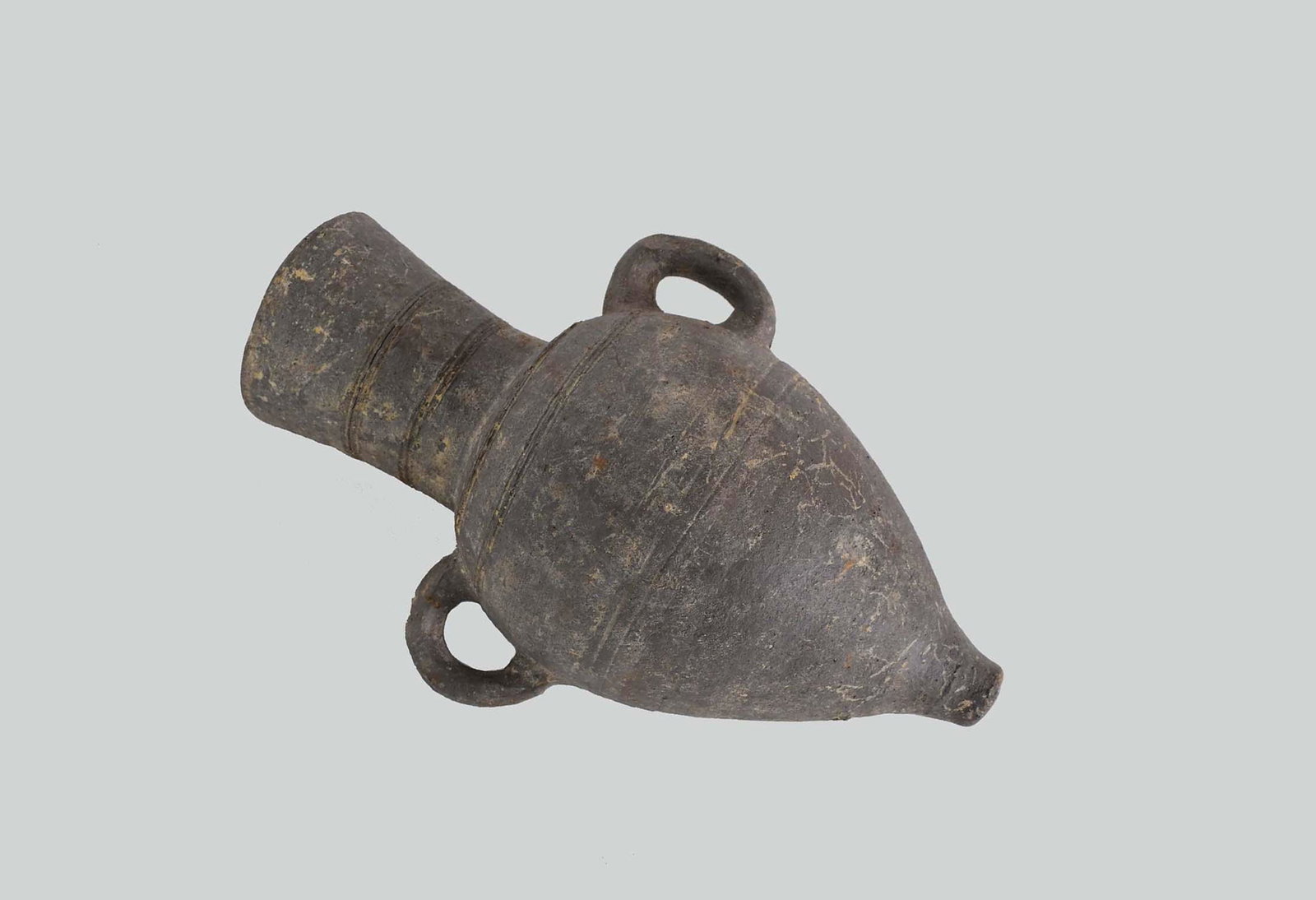 BRONZE AGE GRAY TERRA COTTA DOUBLE-HANDLED AMPHORA: Jericho, B.C.E. 1500. Signed and inscribed in black, Jericho BC 1500, M. Dayan. The tapered gray earthenware vessel with double loop handles at the shoulder, beneath a flared cylindrical neck, decorat
