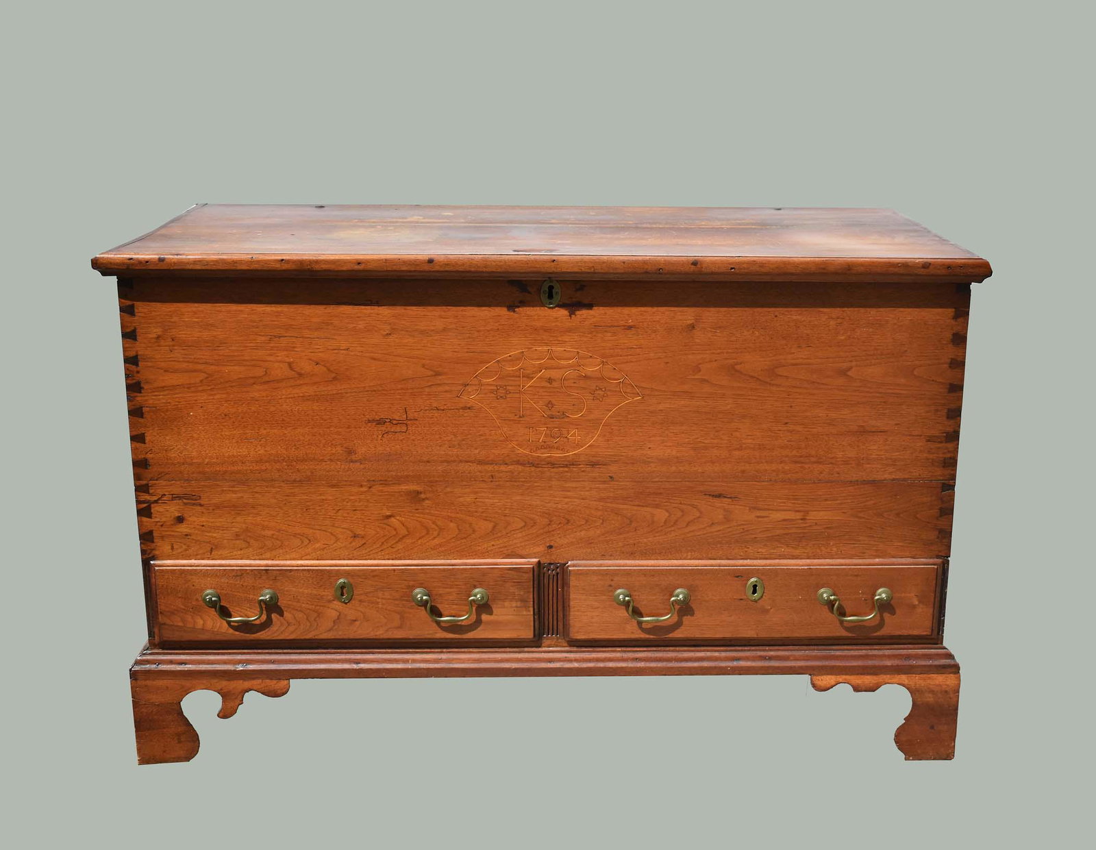 AMERICAN INLAID PINE BLANKET CHEST ON STAND, DATED 1794: Late 18th Century. The rectangular hinged top opening to an interior with a well and till, the front dated 1794, initialed KS, lower facade with two short drawers, divided by a fluted panel, with bail