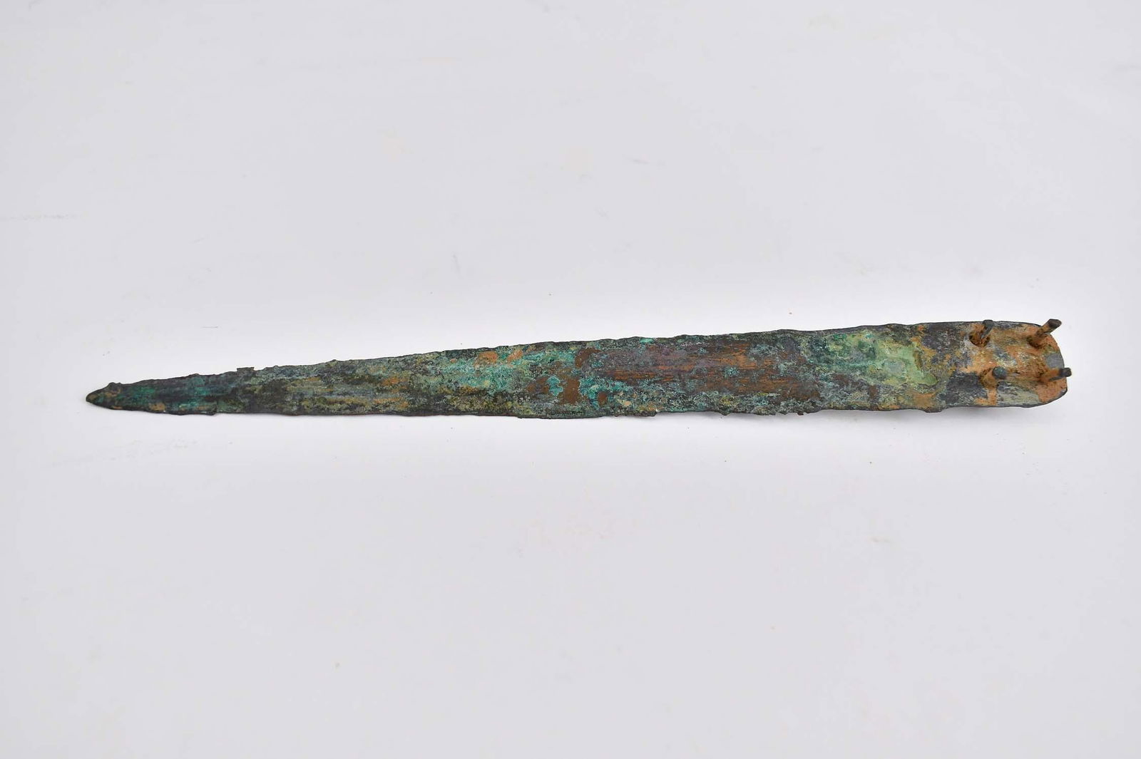 CANAANITE LATE BRONZE AGE BRONZE KNIFE BLADE: B.C.E. 1800 TO B.C.E. 1500. Inscribed in black with JM 123-15. The tapered double edge blade, with four pins to each side to secure to a handle. Length 10 in.Provenance: The Collection of Erwin and Sy