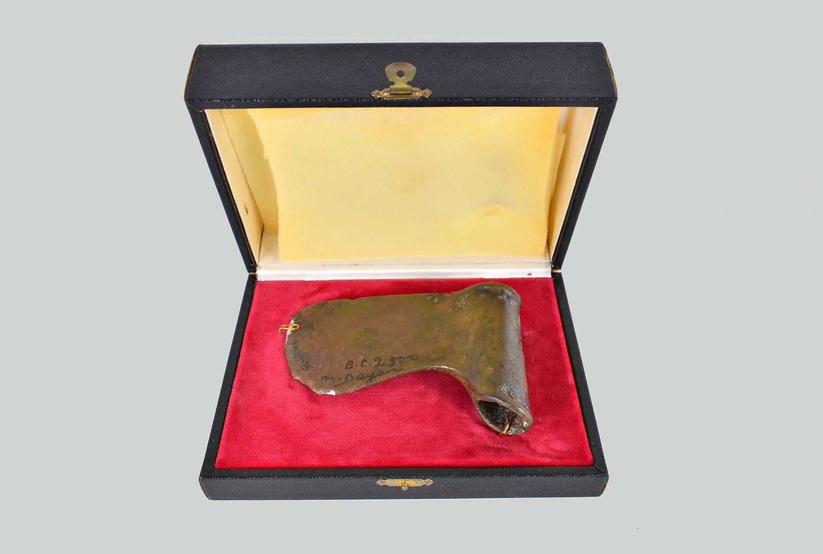 CANAANITE BRONZE AXE HEAD: Late Bronze Age, circa 1800 to 1200 B.C.E. The shaped axe head tapered to a crescent edge, with a cylindrical open socket mount with rolled ends for attachment to the shaft, slight reddish-brown patin