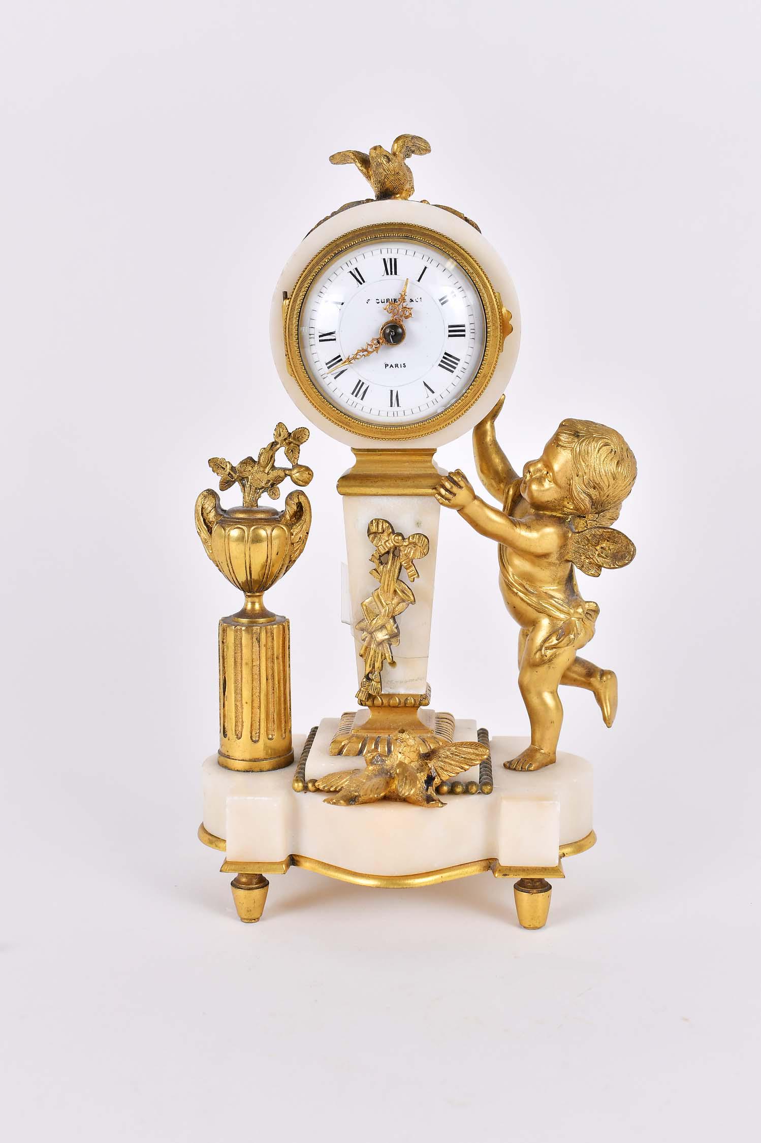 LOUIS XVI STYLE GILT BRONZE & MARBLE SHELF CLOCK: Late 19th Century. The circular enamel dial signed indistinctly, Paris, the circular marble clock drum surmounted by a dove, atop a tapered marble pedestal, flanked by a bronze winged putto and fluted