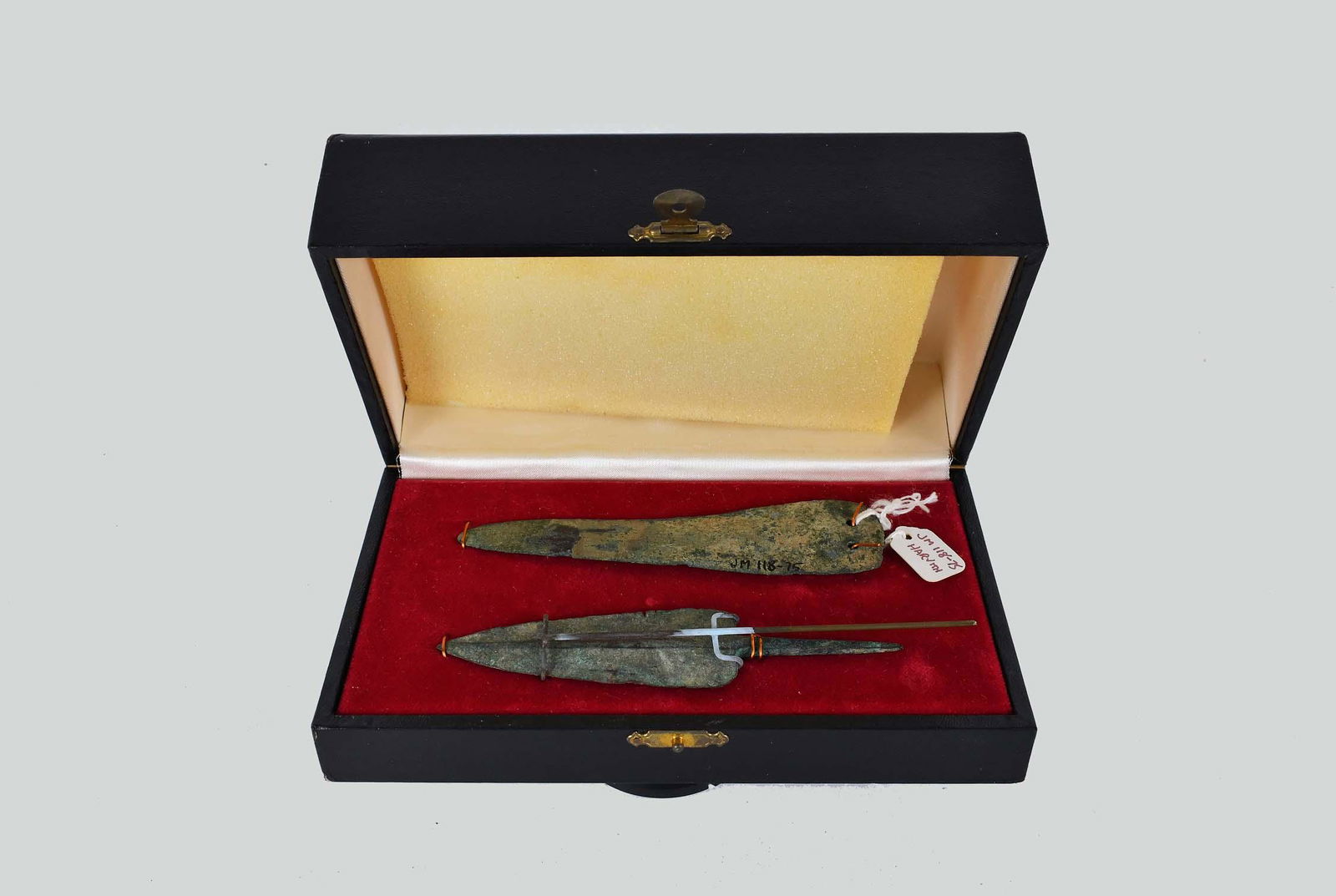 CANAANITE BRONZE SPEAR HEAD & A KNIFE BLADE,: 1800-1500 B.C.E. The first, an arrow-shaped head with fine edges, terminating into a point, the base with an extended tang, possessing an attractive natural greenish blue patina. The blade inscribed w