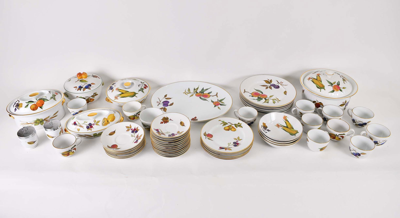 ROYAL WORCHESTER EVESHAM PORCELAIN PART TABLE SERVICE: The underside of each marked. Each piece of the forty-five pieces painted with produce. Comprising: six dinner plates, six luncheon plates, six dessert plates, four bowls, an oval platter, a large cov