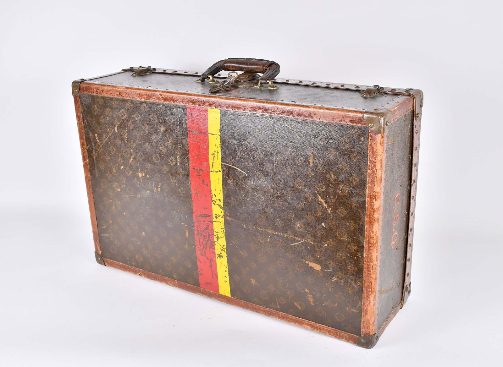 VINTAGE LOUIS VUITTON MONOGRAMMED CANVAS HARD CASE: The clasp on the lock plate and clasps incised LV, lower part also marked Louis Vuitton / Made in France, the lock numbered 167264, with patinated brass/copper lock plate, clasps, and corner mounts, t