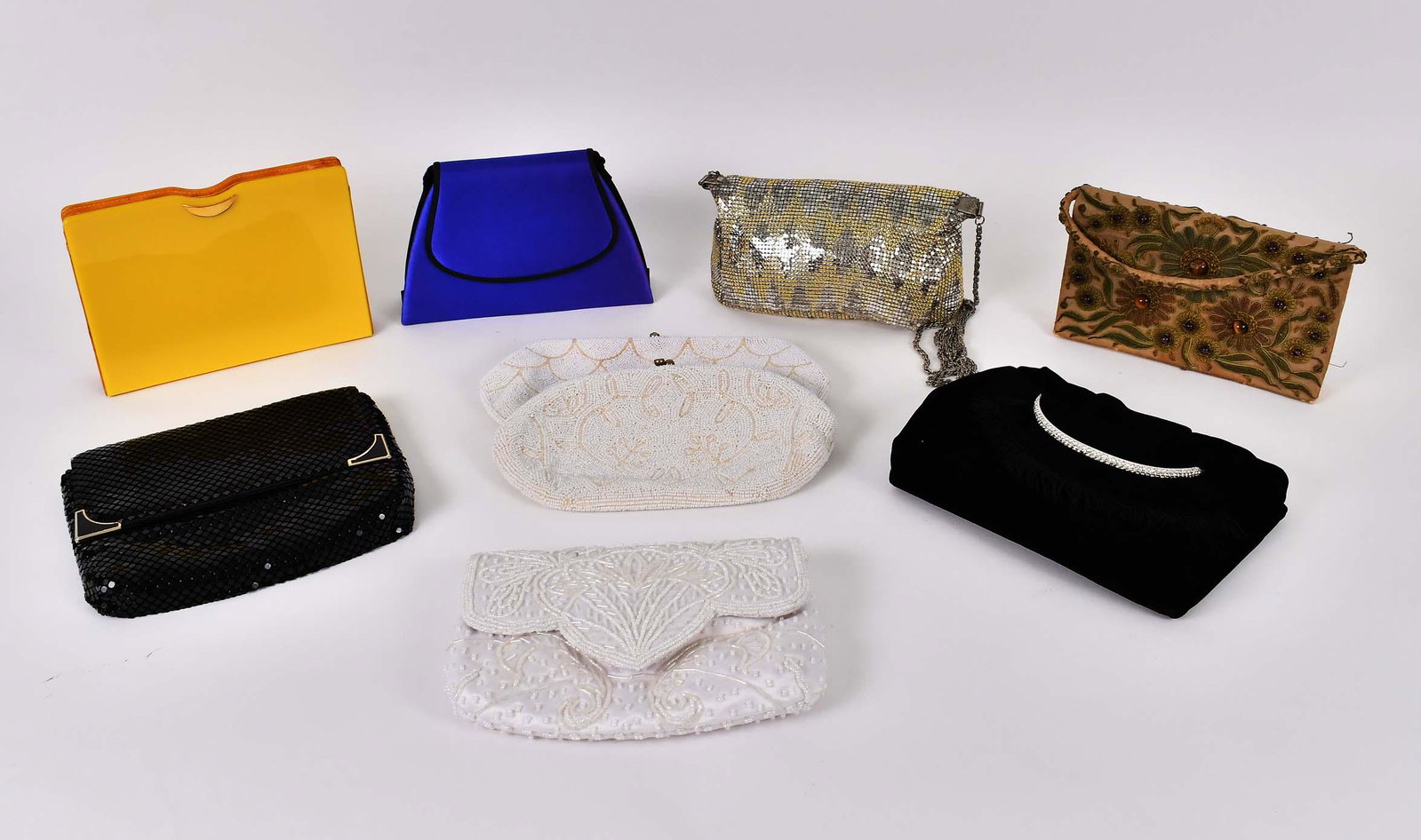 NINE VINTAGE BEADED & CONTEMPORARY EVENING PURSES: Including: three white beaded examples, an embroidered gilt brocade and cats eye mounted example, a faux diamond mounted black fabric bag, a gold metal mesh example, a similar black example, a yellow 