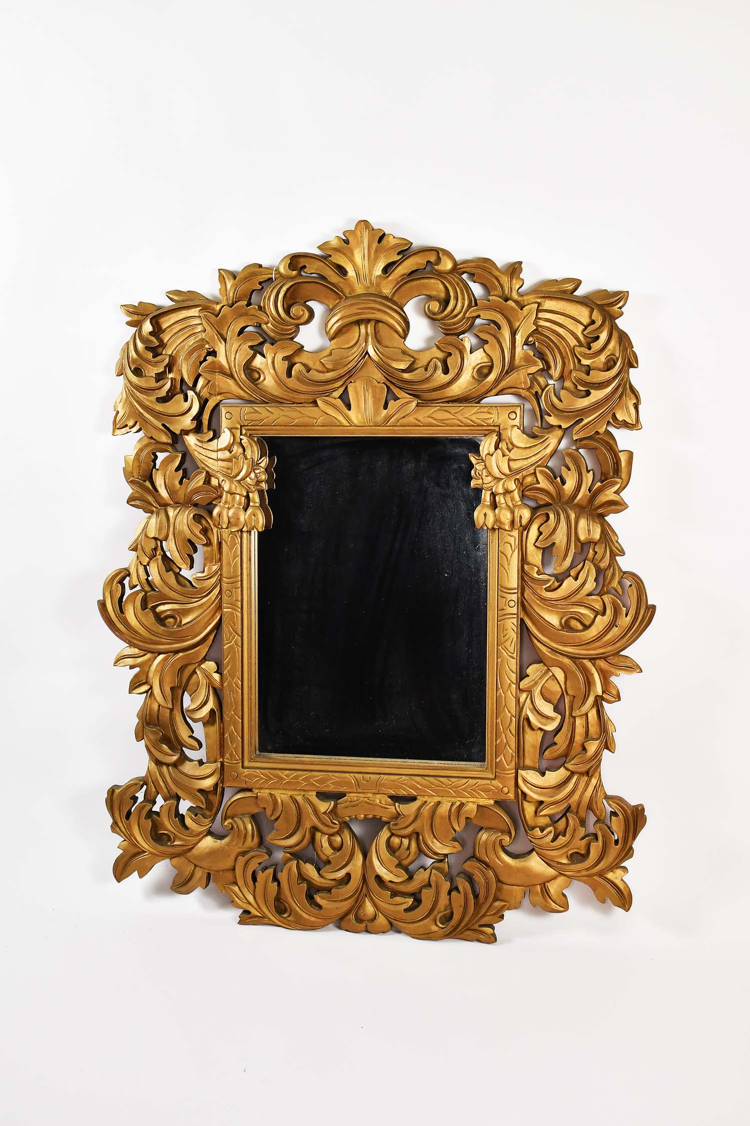 BAROQUE STYLE GILT PAINTED WOOD MIRROR: The rectangular plate within a surround heavily carved with leafage and scrolls. Height 53 in. Width 41 in. (Cond: good)