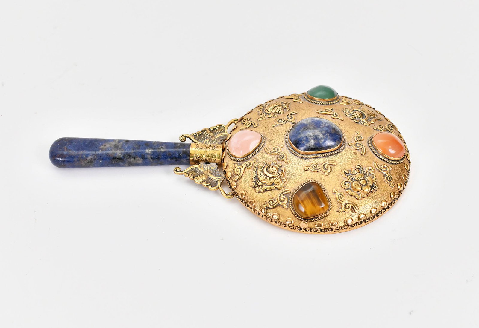 CHINESE STONE MOUNTED GILT METAL HAND MIRROR: With a lapis handle and set with various polished minerals. Length 8 in. Diameter of plate 4 in. (Cond: good)