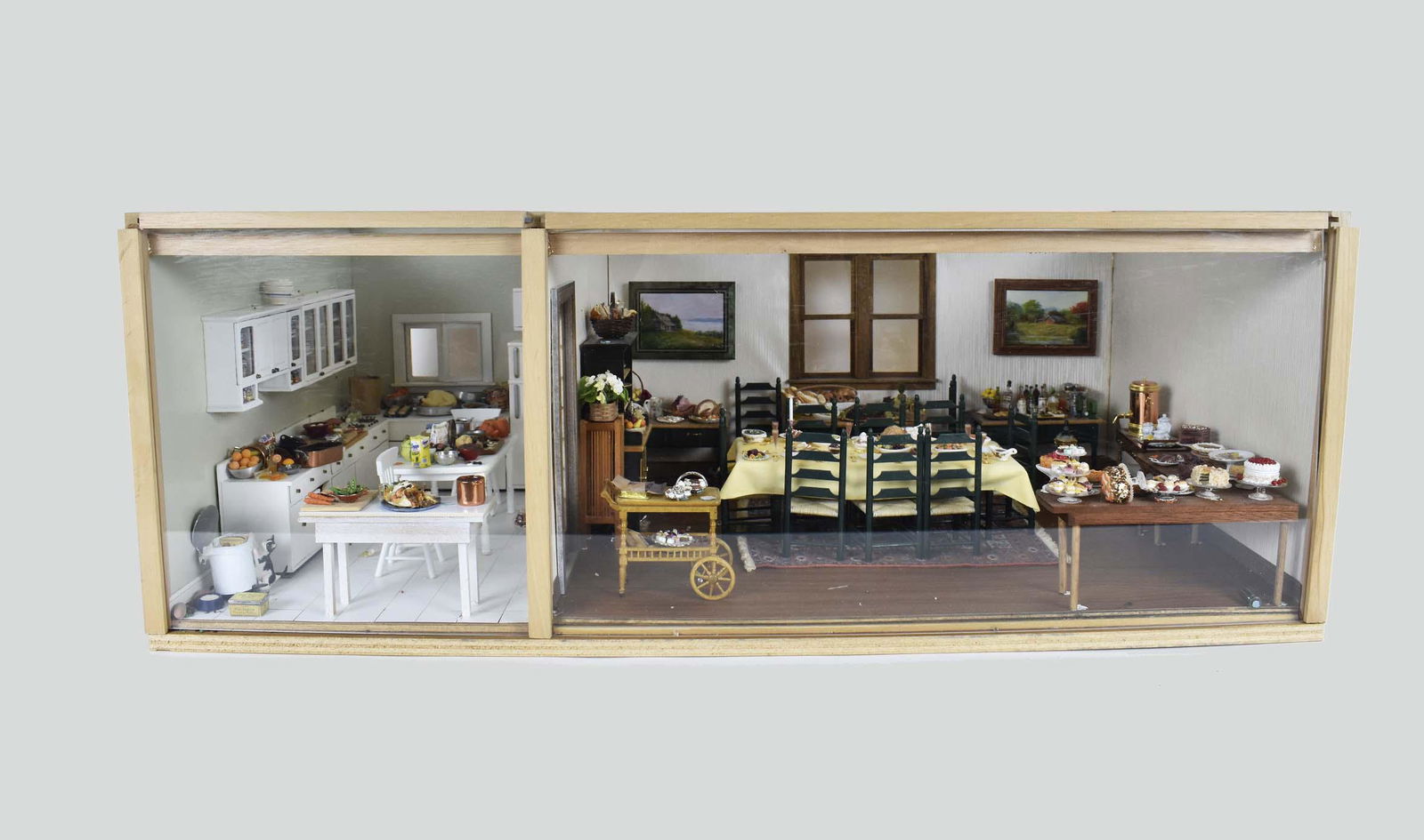 TWO MINIATURE FURNITURE GROUPS & ASSORTED FURNITURE: Hand-crafted, contained in a display. The first, a large dining room with a table set for eight, sideboards, cupboards and tables stacked with an abundance of food for a holiday dinner. The second, a