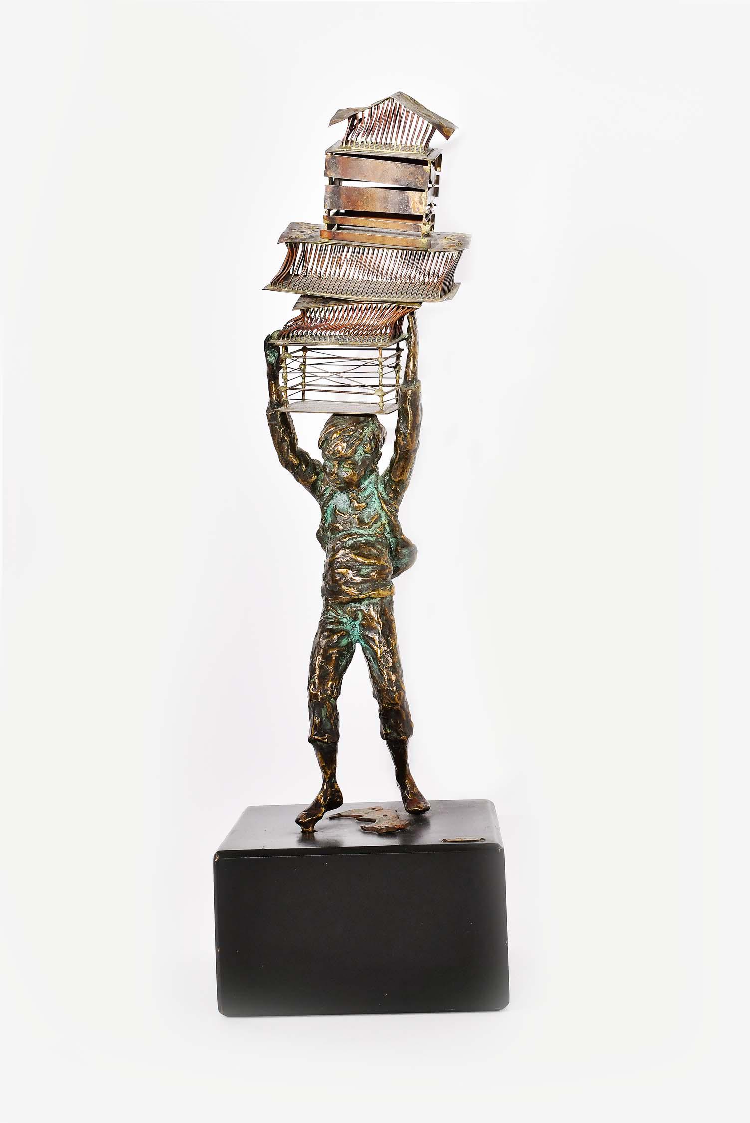VINTAGE SCULPTURE OF A FIGURE OF A BOY: The standing boy balancing a stack of cages upon his head, on an ebonized wood base. Height 15 in., overall 18.5 in. (Cond: good)