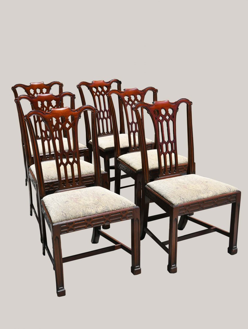 SET OF SIX GEORGE III STYLE MAHOGANY SIDE CHAIRS: Early 20th Century. In the Director style, serpentine cresting over a tapered pierced splat, with drop-in seats above a fret-carved seat rail, on carved squared legs, joined by stretchers, ending in b