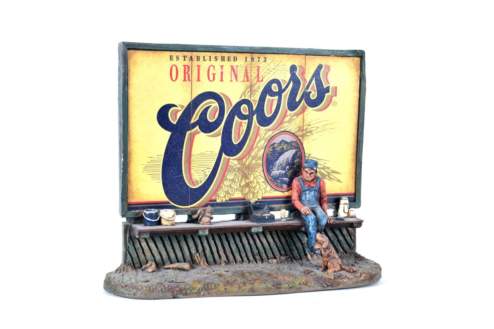 MICHAEL GARMAN COORS BILLBOARD SCULPTURE: Signed and dated 1984. Composition. Height 10.25 in. Width 10.75 in. (Cond: good)
