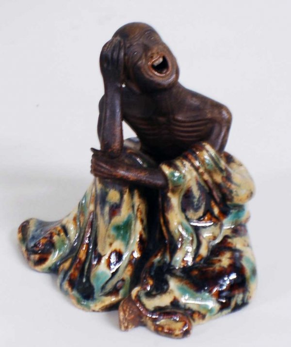 PARTIALLY GLAZED POTTERY FIGURE OF A MONK