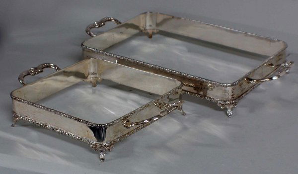 TWO STERLING SILVER DISH HOLDERS: TWO STERLING SILVER DISH HOLDERS Mexican. Each of rectangular shape with branch form handles and scroll cast edges, raised on leaf feet. Length 18 1/4". (Now with Pyrex inserts) (48 oz) (300/500)