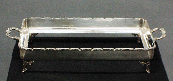 PAIR OF STERLING SILVER DISH HOLDERS: PAIR OF STERLING SILVER DISH HOLDERS Mexican. Each of rectangular shape with scroll rims and foliate handles. Length 17 3/4". (Now with Pyrex inserts) (54 oz) (400/600)