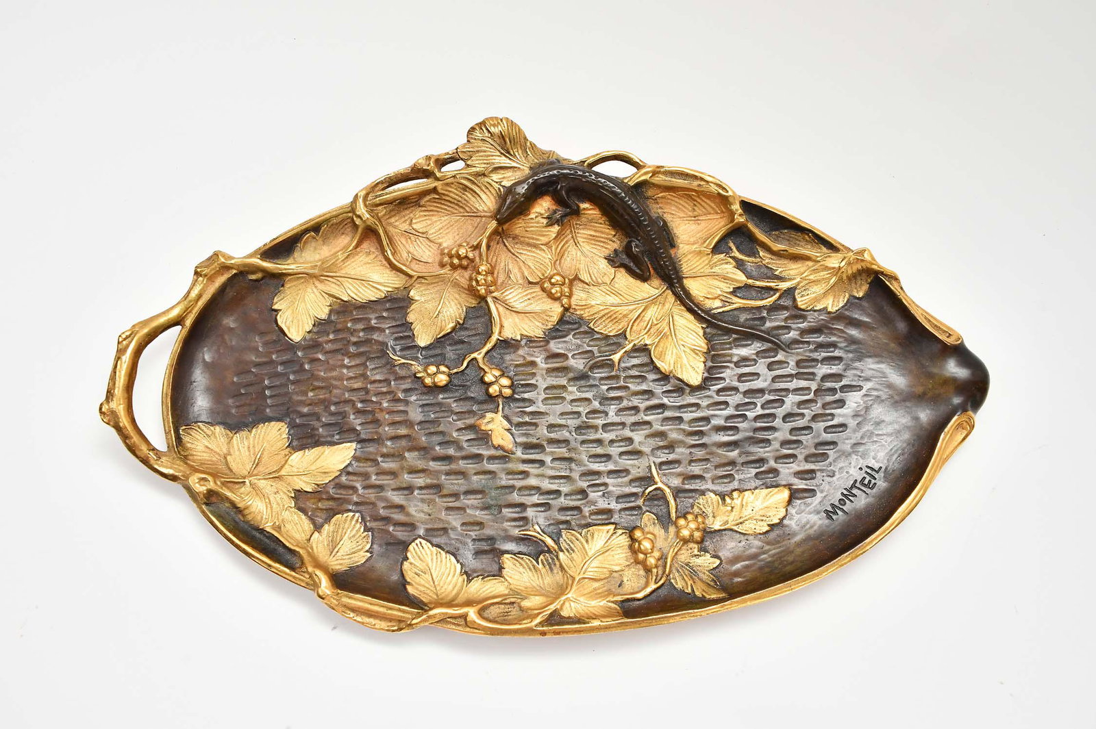 FRENCH PATINATED AND GILT BRONZE VANITY TRAY: Early 20th Century. Signed Monteil. The shaped tray with a handle at one side, cast with a lizard atop leaves. Length 14.5 in. Depth 9 in. (Cond: good)